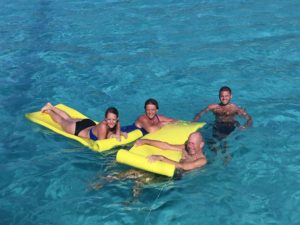 four people floating in the sea