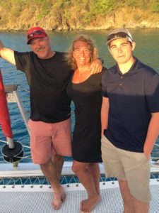 a family of three on a yacht during sunset